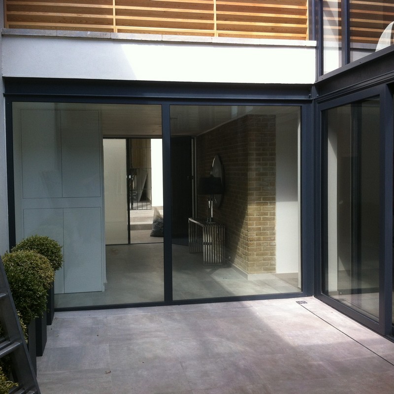 Floor-to-ceiling sliding doors opening to courtyard in Peckham