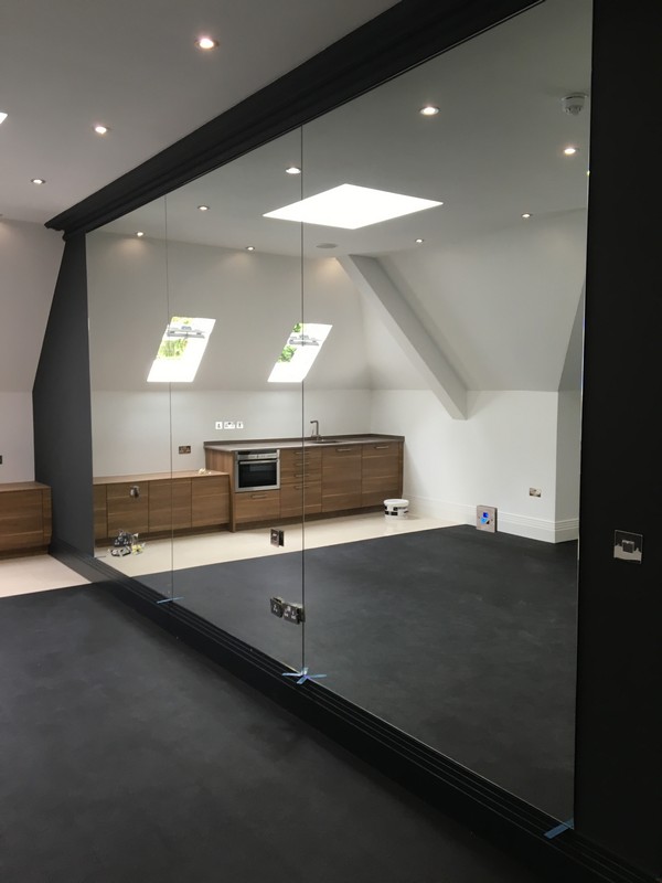 Frameless glass partition in loft conversion by Peckham glaziers