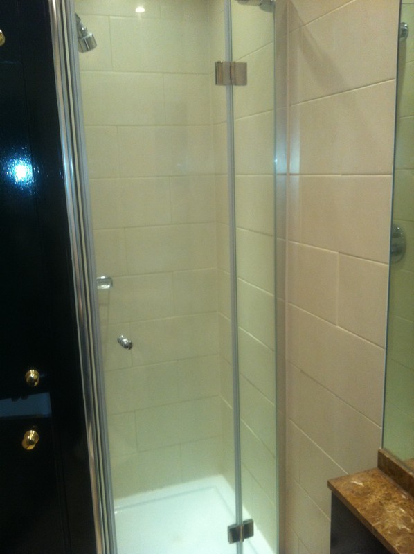 Frameless glass shower enclosure with chrome fittings in Peckham