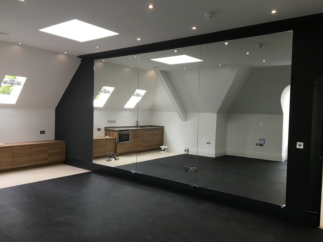 Frameless glass wall dividing loft conversion in Peckham