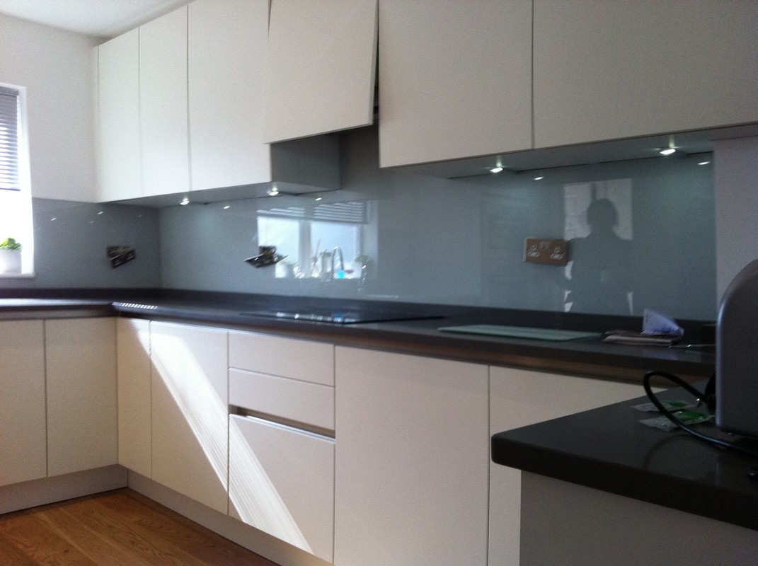 Grey glass kitchen splashback with LED lighting in Peckham