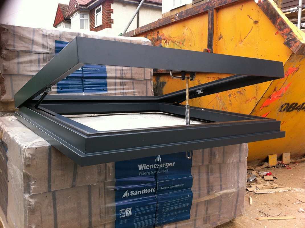 Opening flat roof skylight in anthracite grey installed in Peckham
