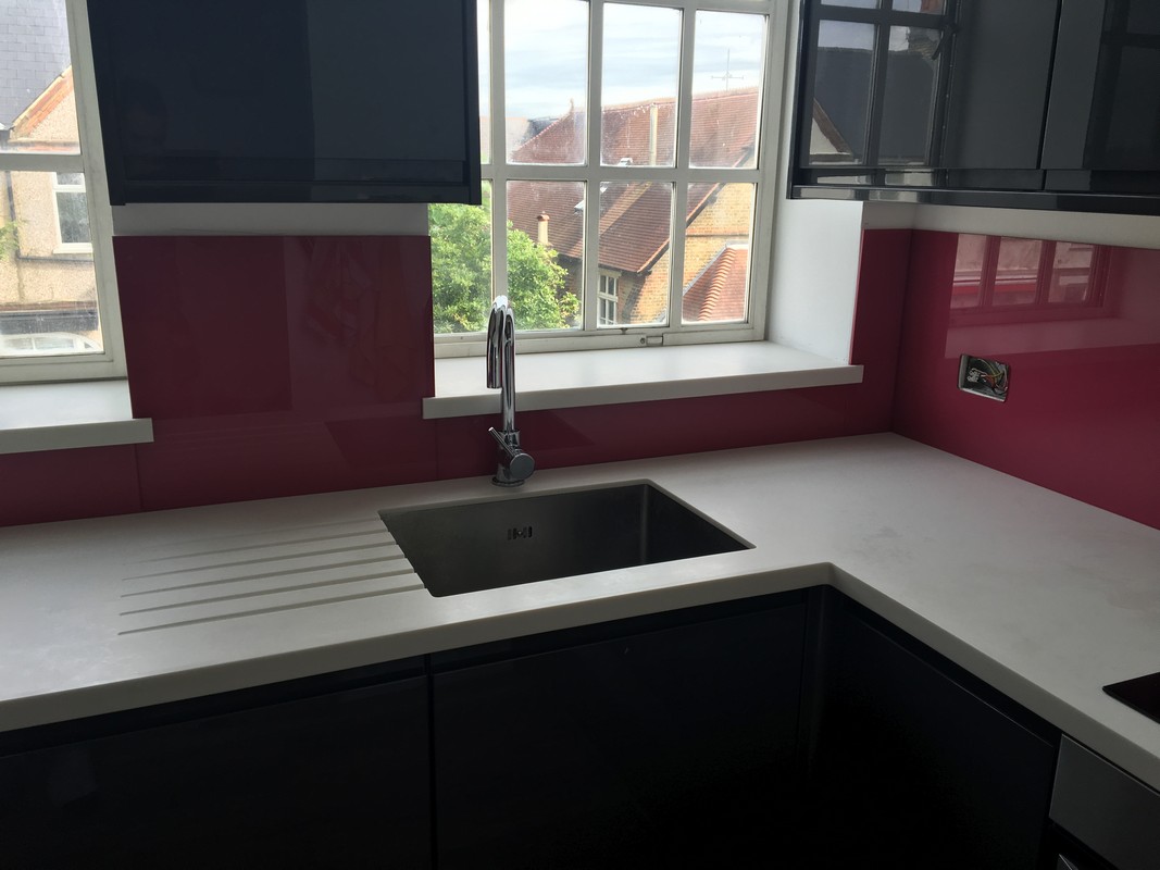 Deep plum coloured glass splashback in modern Peckham kitchen