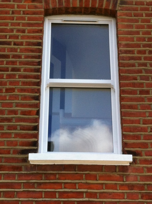uPVC sash window on Victorian red brick house in Peckham